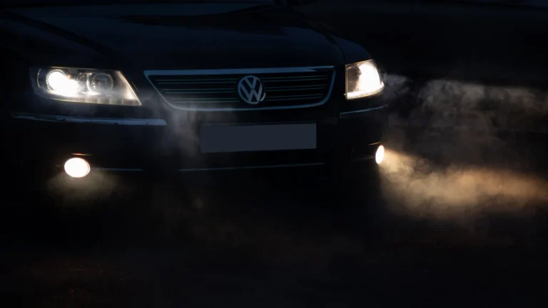 Car headlights illuminating the road at night